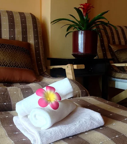 towels on a chair with a flower on top at Nakhon Thai Massage in Parnell Auckland, the Best Thai Massage in Auckland