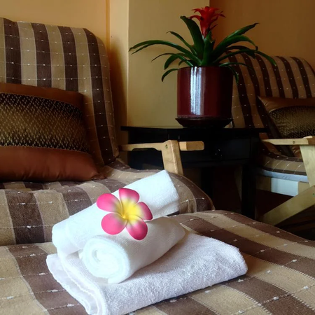 towels on a chair with a flower on top at Nakhon Thai Massage in Parnell Auckland, the Best Thai Massage in Auckland